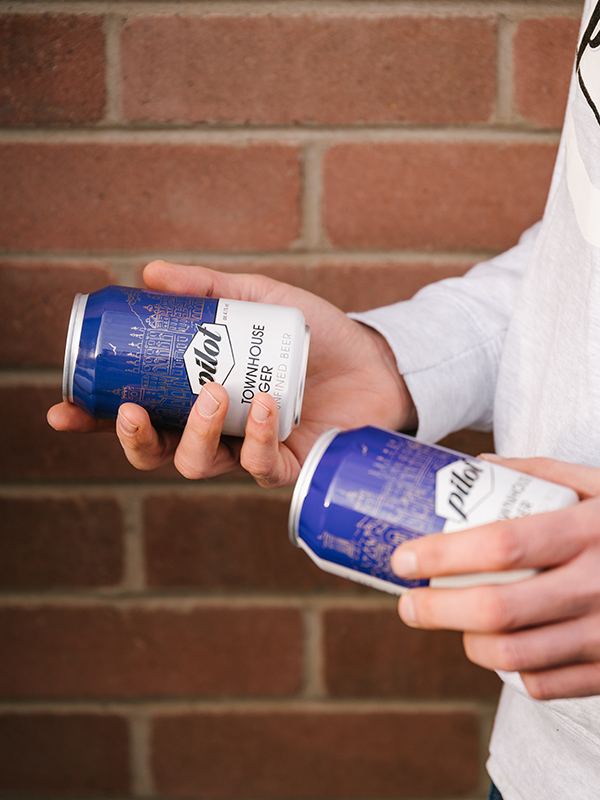 Two cans of Pilot beer in someone's hands at Gleneagles Townhouse