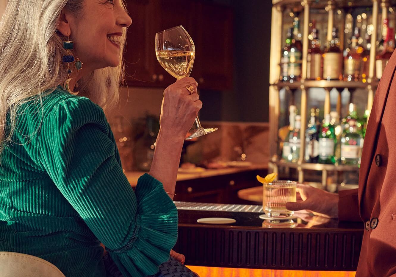 A woman enjoying a glass of wine in Lamplighters