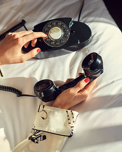 A woman's hands dialling on a phone at Gleneagles Townhouse