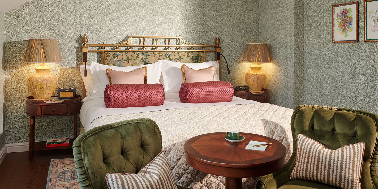 A Nook room with double bed and green velvet chairs