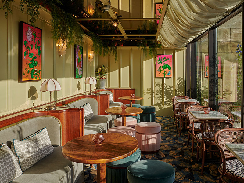 Bay seating and green panelled walls in front of the windows in Lamplighters