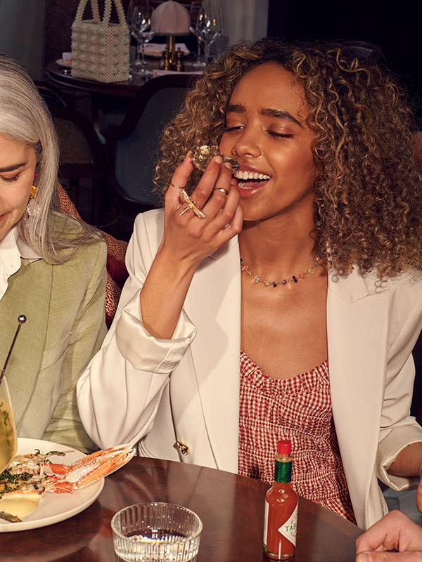 A woman eats an oyster at Gleneagles Townhouse