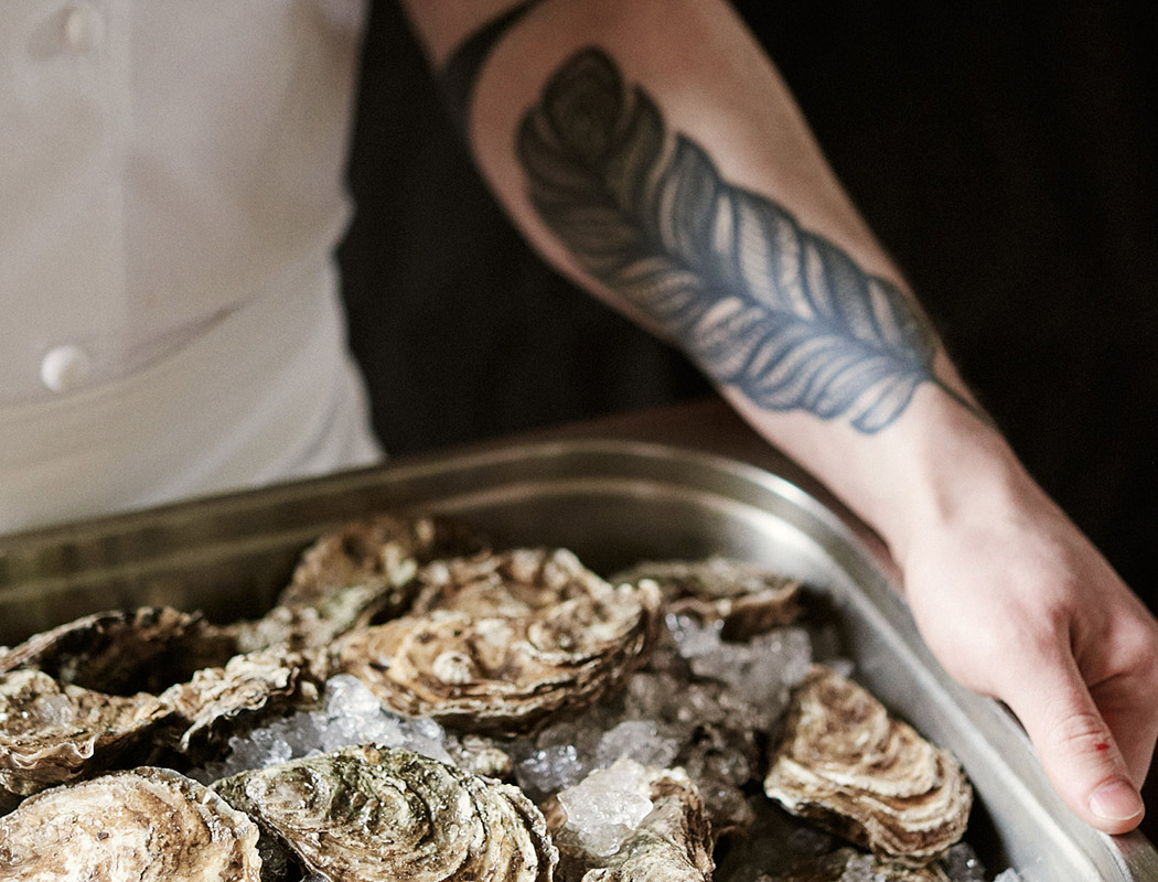 Chef carrying a tray of oysters at Gleneagles Townhouse
