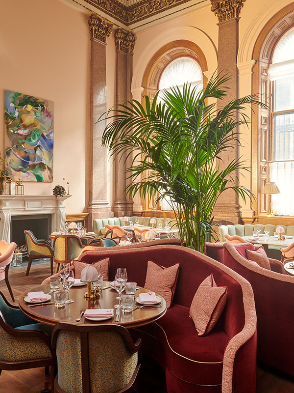 Dining area in The Spence with red sofa