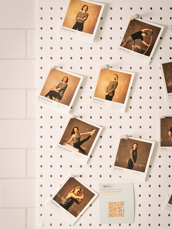 A pin board in the gym with profiles of our wellness educators