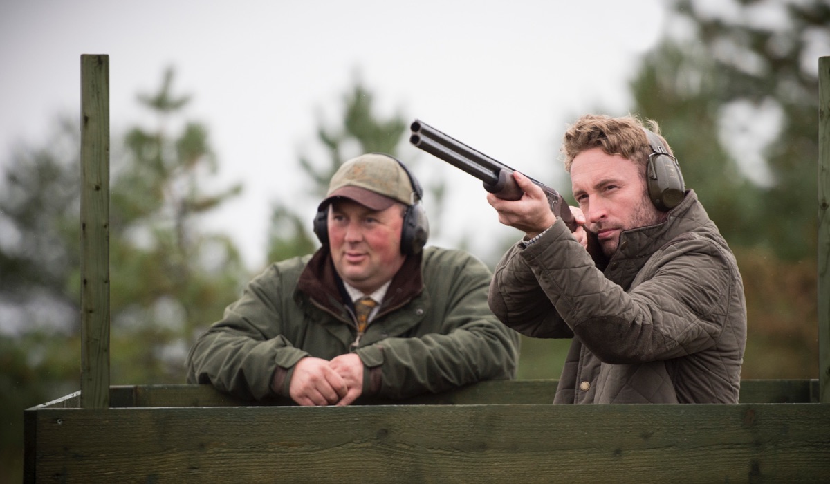 An instructor and a client shooting clays