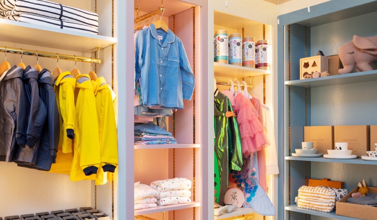Brightly coloured kids clothes on racks in Hop & Scotch