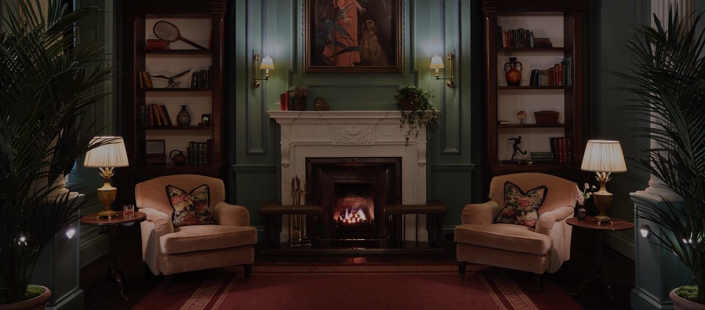 The Parlour room at gleneagles with open fire and arm chairs