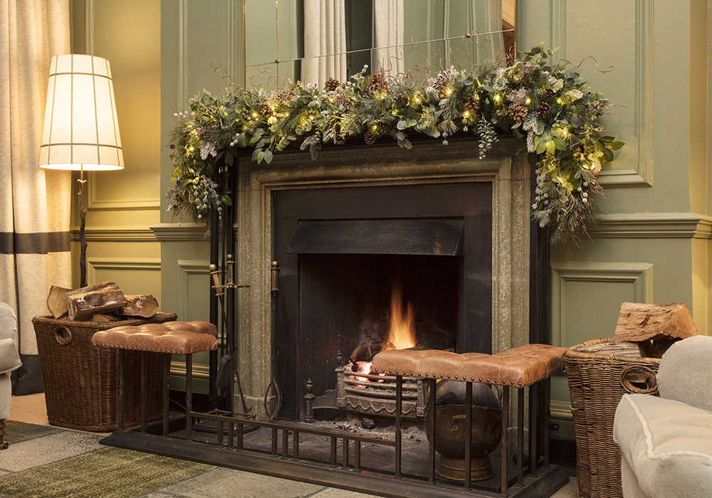 A roaring fire in the lobby at Gleneagles surrounded by Christmas decorations