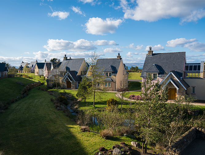 Glenmor lodges on a bright sunny day surrounded in grass and trees