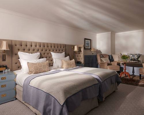 Tw large single beds next to each other in a suite bedroom