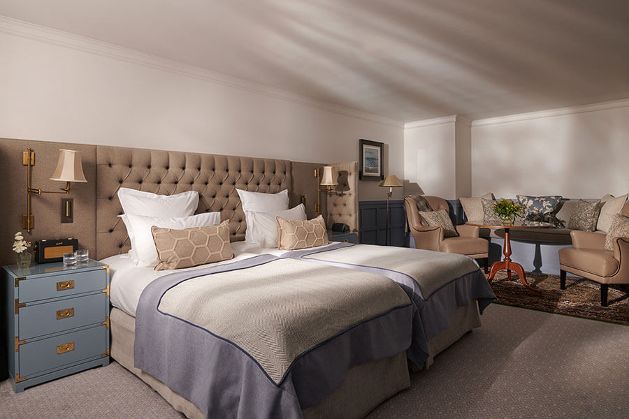 Tw large single beds next to each other in a suite bedroom