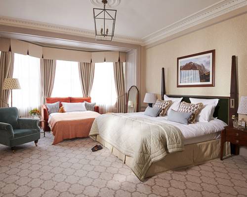 a large bedroom with extra bed for a child