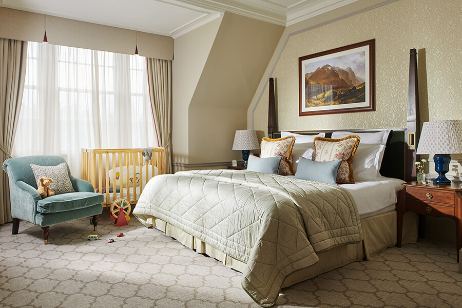 A large bedroom with cot and child's toys