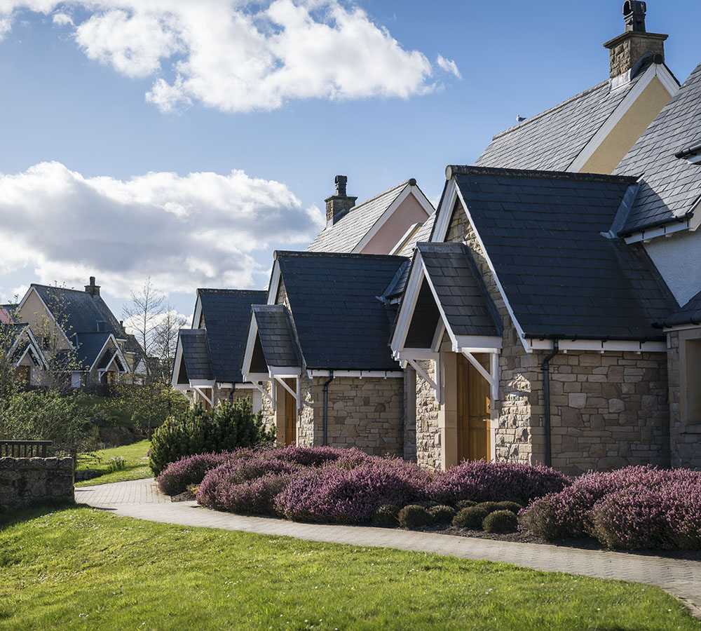Luxury Glenmor lodges next to each other on a bright sunny day