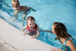 A mother with her son and daughter in a pool