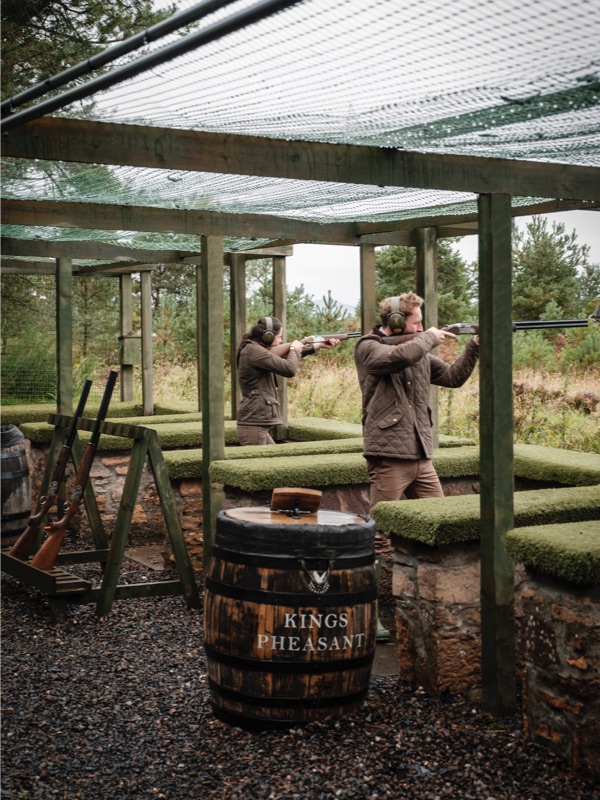 A couple shoot clays from a range at Gleneagles