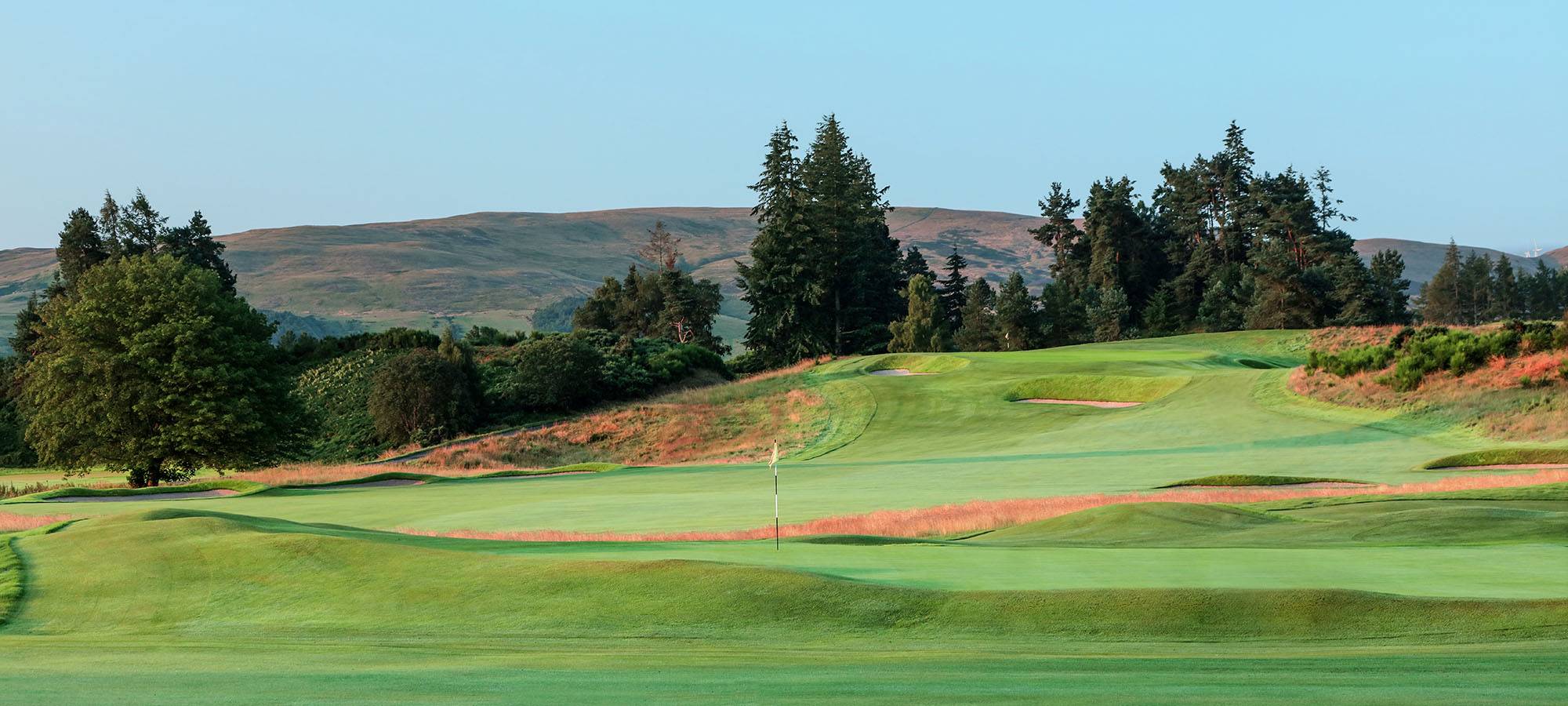 A golf green at sunset