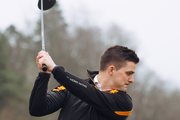 A golfer practices his swing