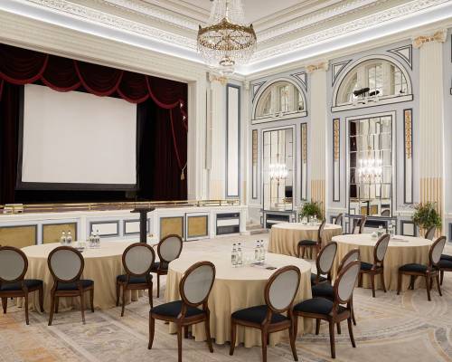 The ballroom set for a presentation with cabaret tables, projector and screen