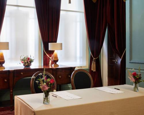 A table set up for a private checkin in the parlour room