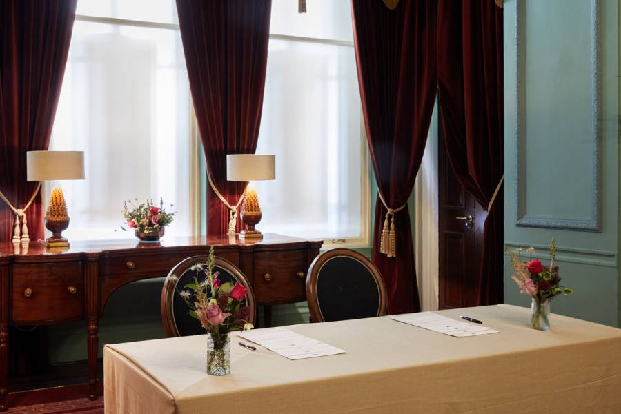 A table set up for a private checkin in the parlour room