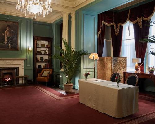 A wide shot of a table set up for a private checkin in the parlour room at gleneagles