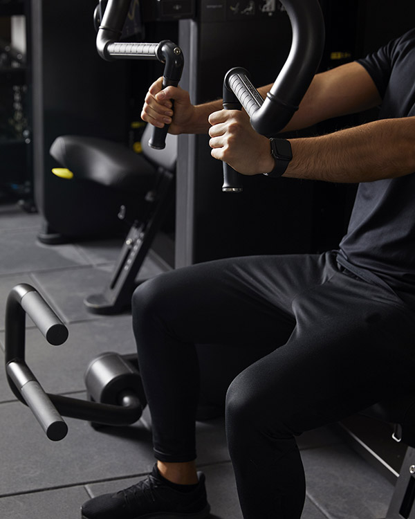 A man in the Gleneagles gym using chest press equipment