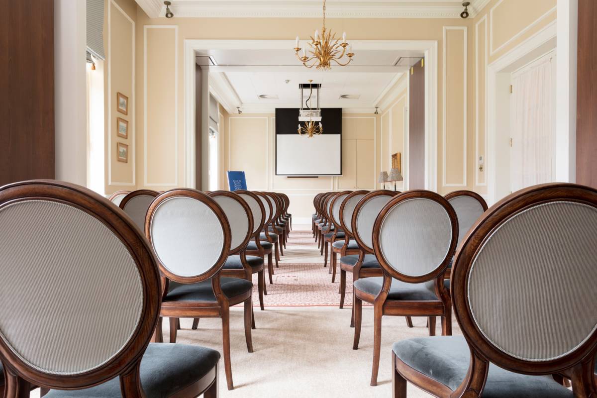 The assembly room set up theatre style at Gleneagles with long rows of chairs in front of a projector screen