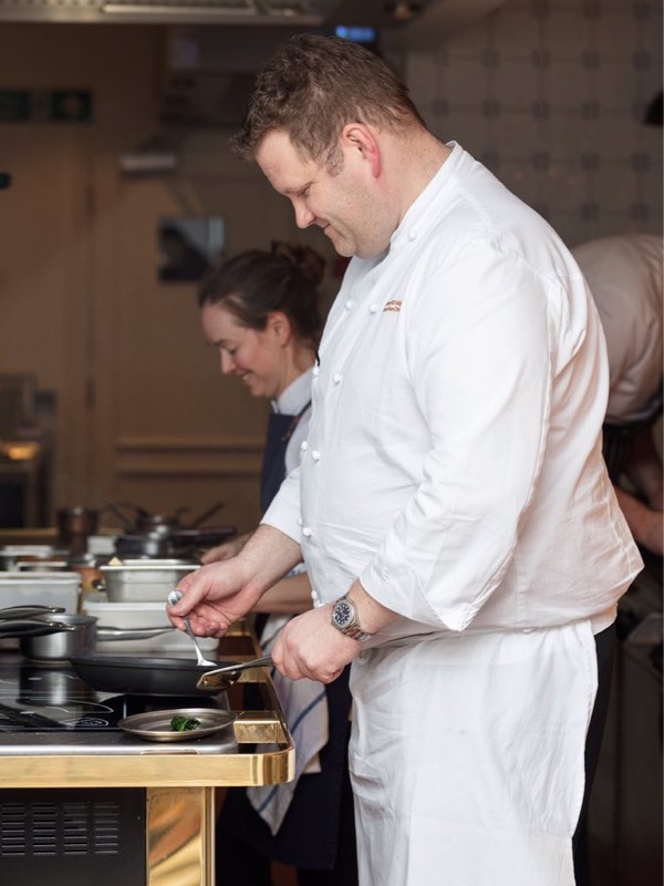 Simon attridge cooks in a kitchen