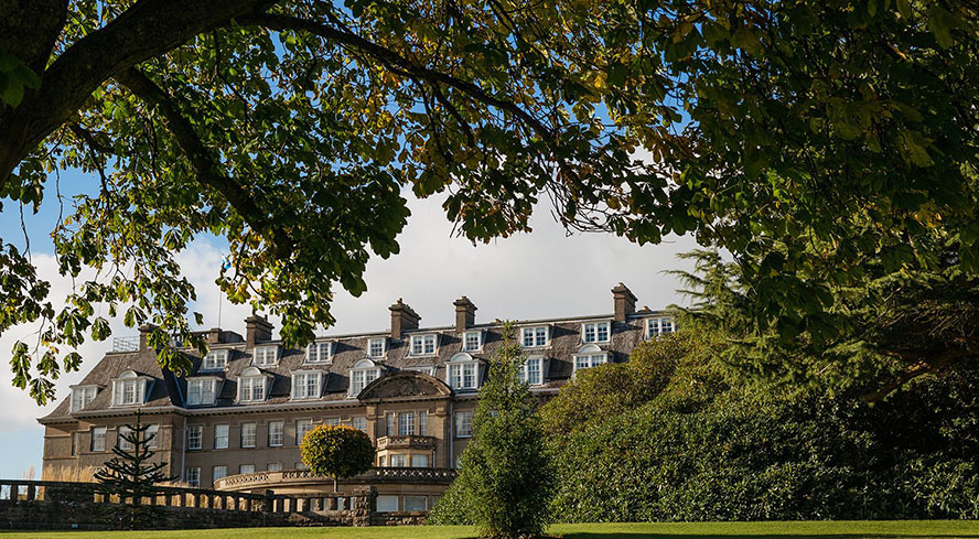 The exterior of Gleneagles shot through trees