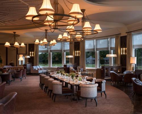 A long table set up for a banquet at night time in the Glendevon room