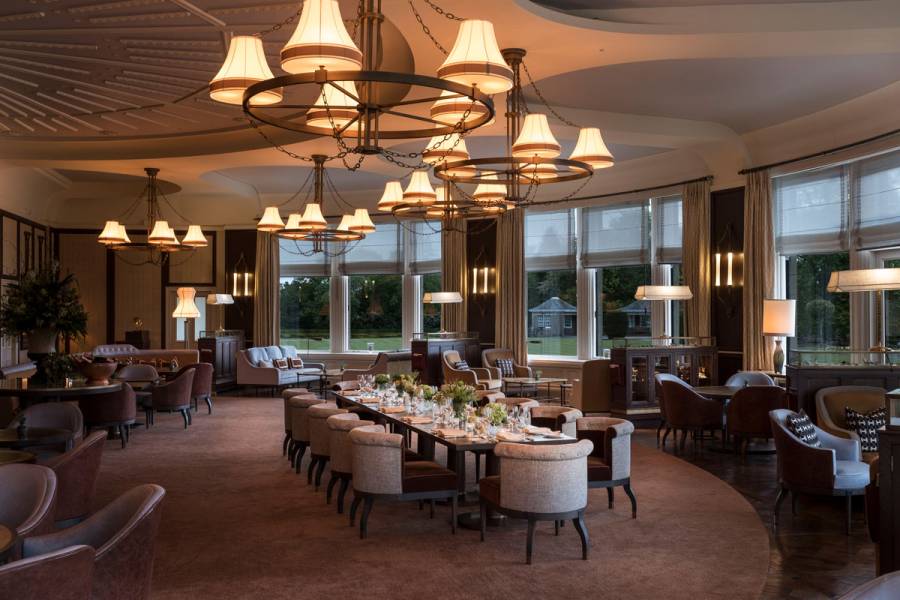 A long table set up for a banquet at night time in the Glendevon room