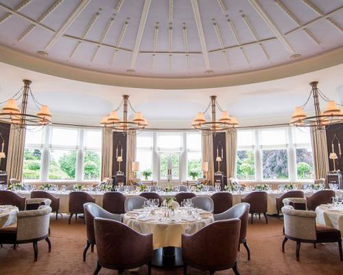 Tables of five set for a private dinner with Windows overlooking the lawn at Gleneagles