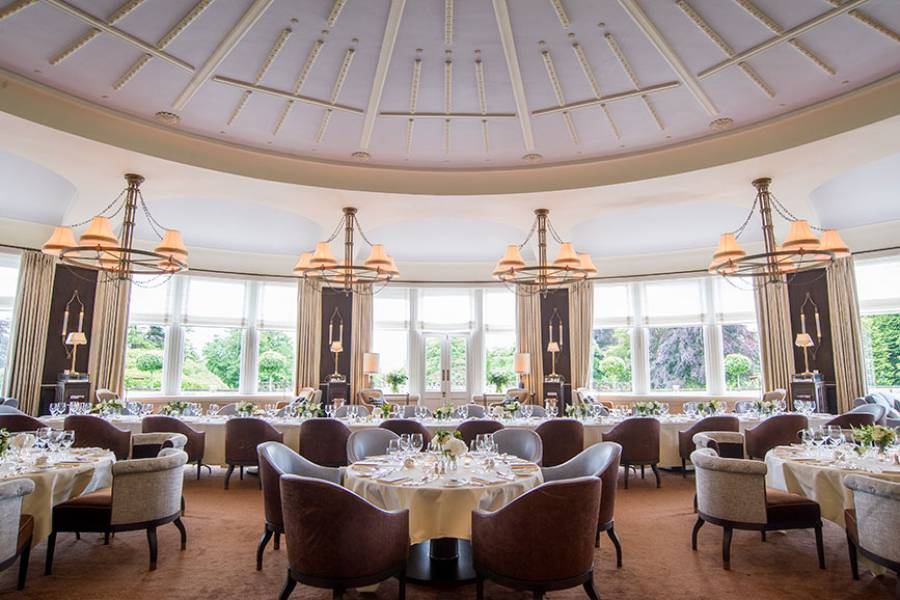 Tables of five set for a private dinner with Windows overlooking the lawn at Gleneagles