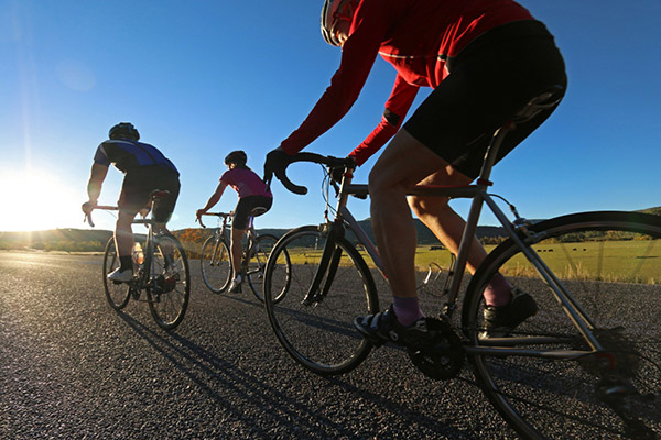 Trio of road cyclists in fall season