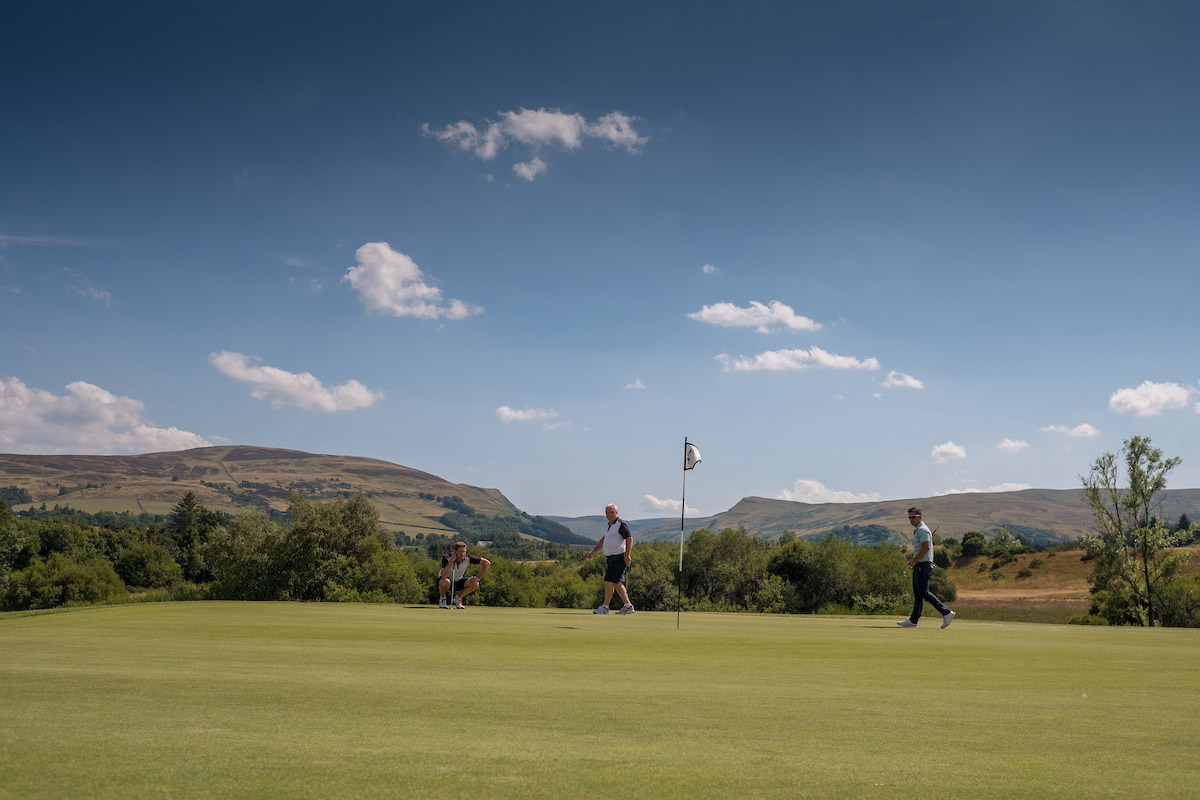 Golfers putting on course at Gleneagles