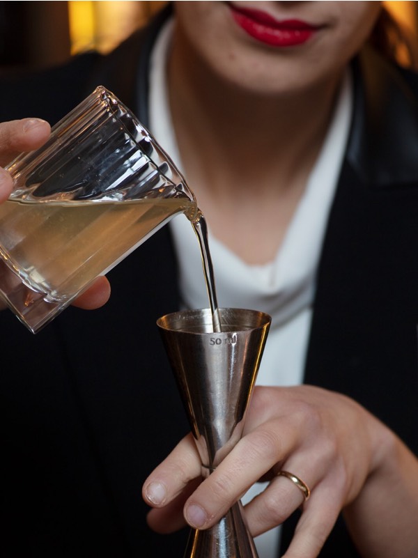 Lulu Fedi pours alcohol in a measure