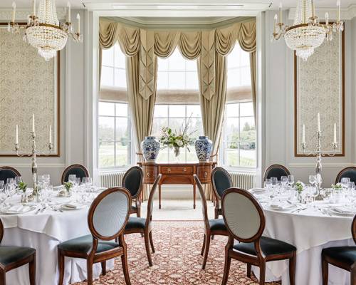 A beautiful room set up with large runs table for a dinner