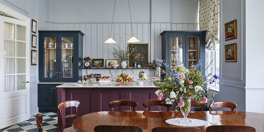A large highly polished wooden table in front of a breakfast bar in the pantry at Gleneagles