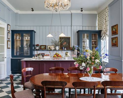 A large highly polished wooden table in front of a breakfast bar in the pantry at Gleneagles
