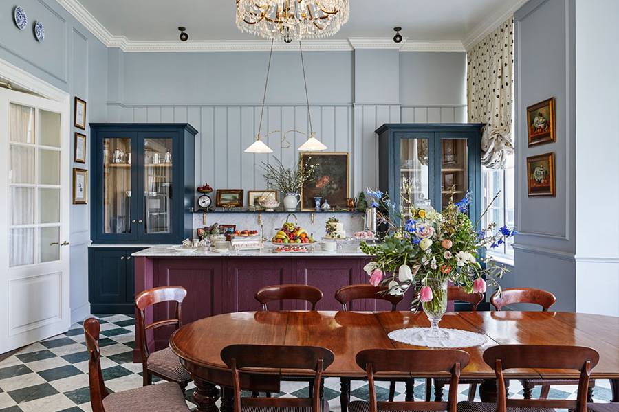 A large highly polished wooden table in front of a breakfast bar in the pantry at Gleneagles