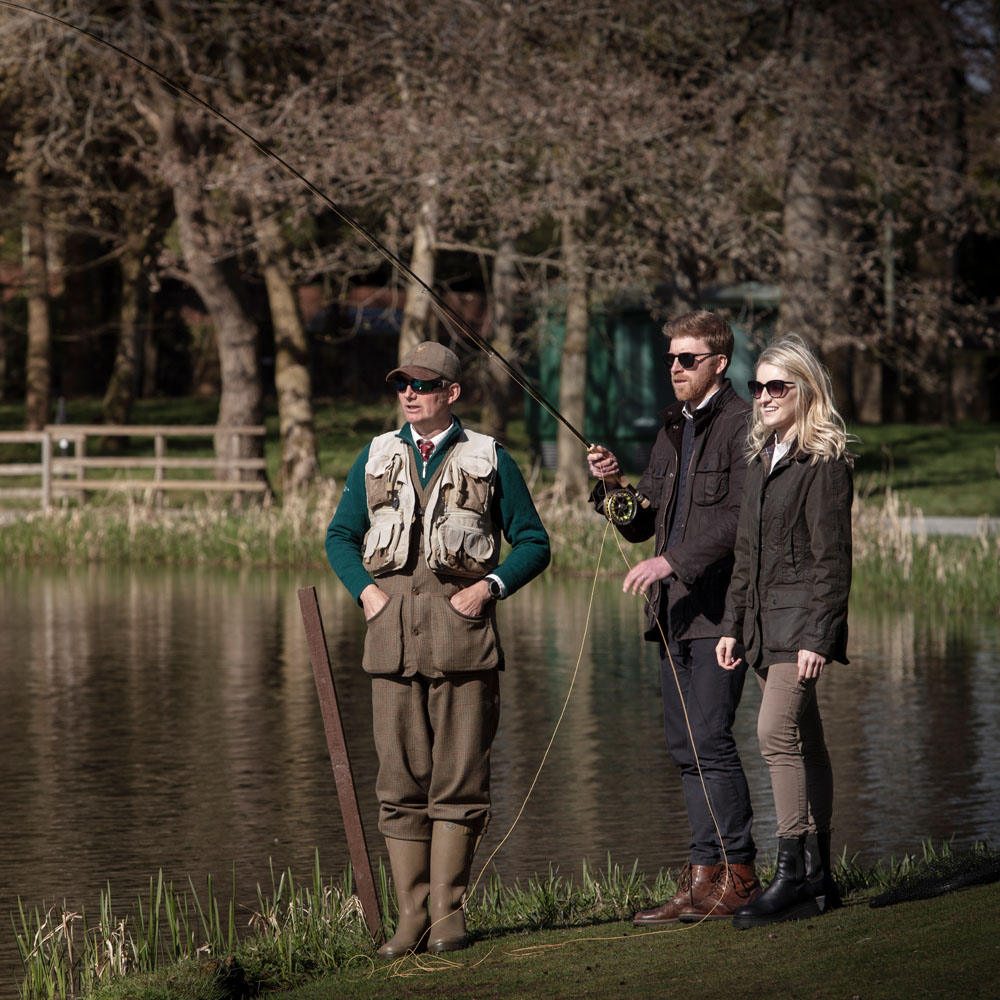 Three people fishing on Laich Loch at Gleneagles