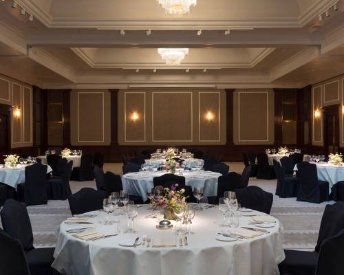 The Henry hall set up for dinner with large round tables