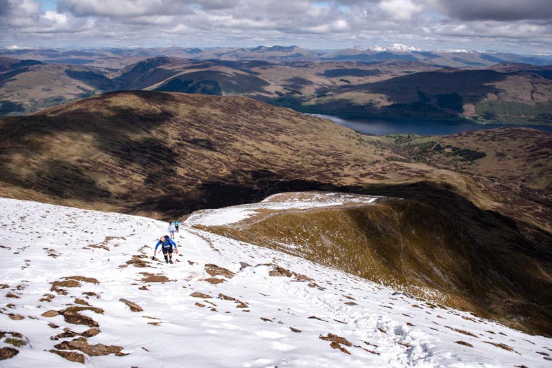 Runners climb through the snow on Ben Vorlich