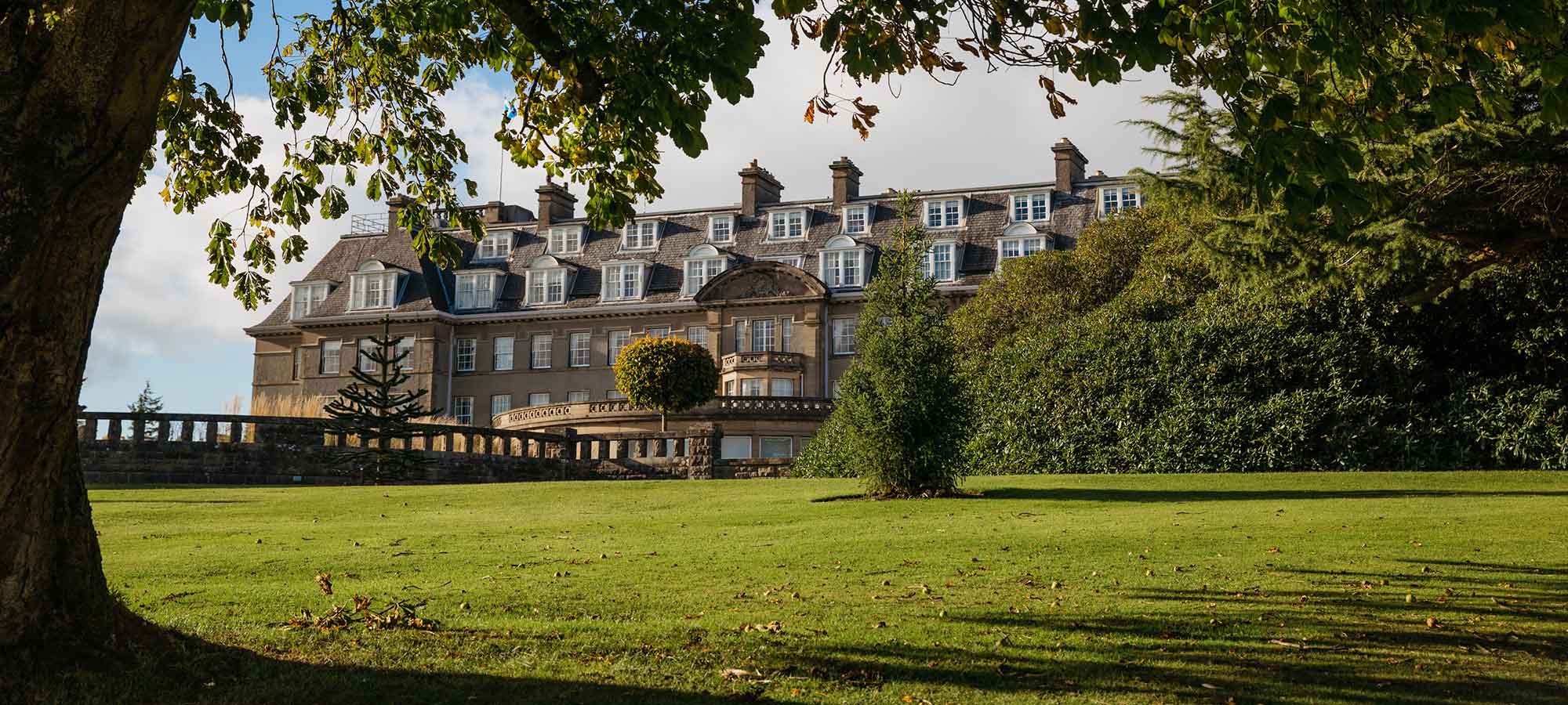 The Gleneagles Hotel behind some trees