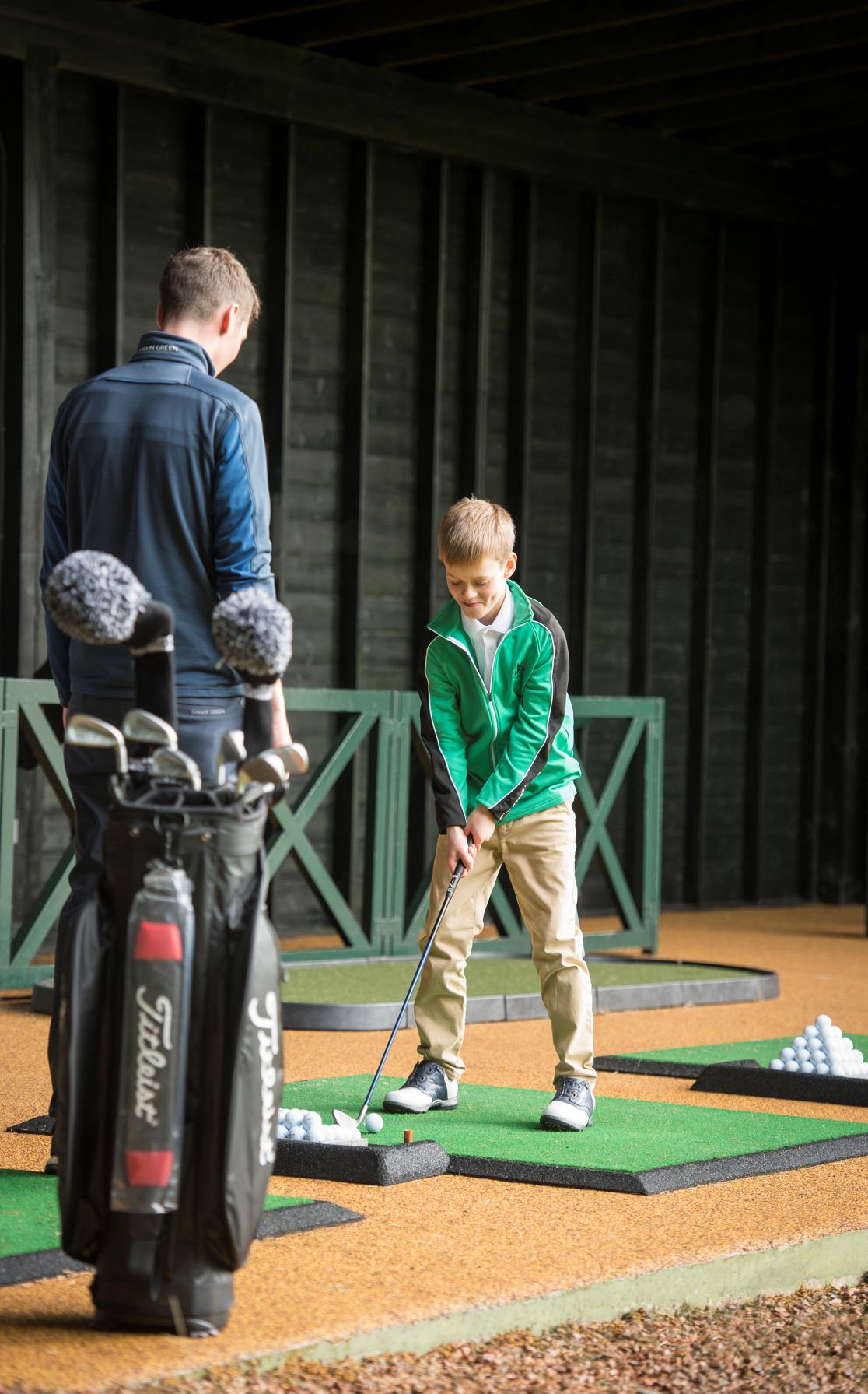 Young boy having a golf lesson with a PGA coach