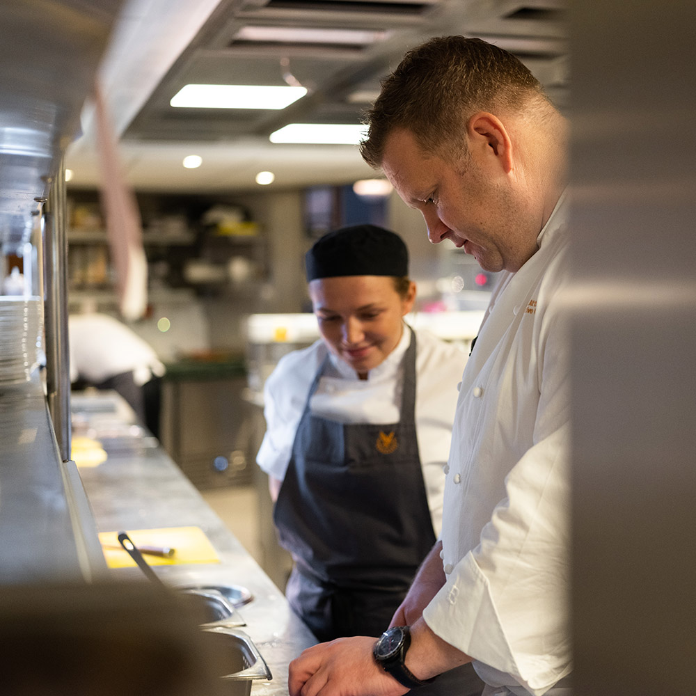 Chef Simon Attridge teaches a younger chef at Gleneagles