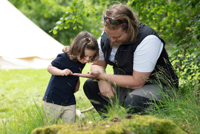 Boy and outdoor activities manager bug hunting