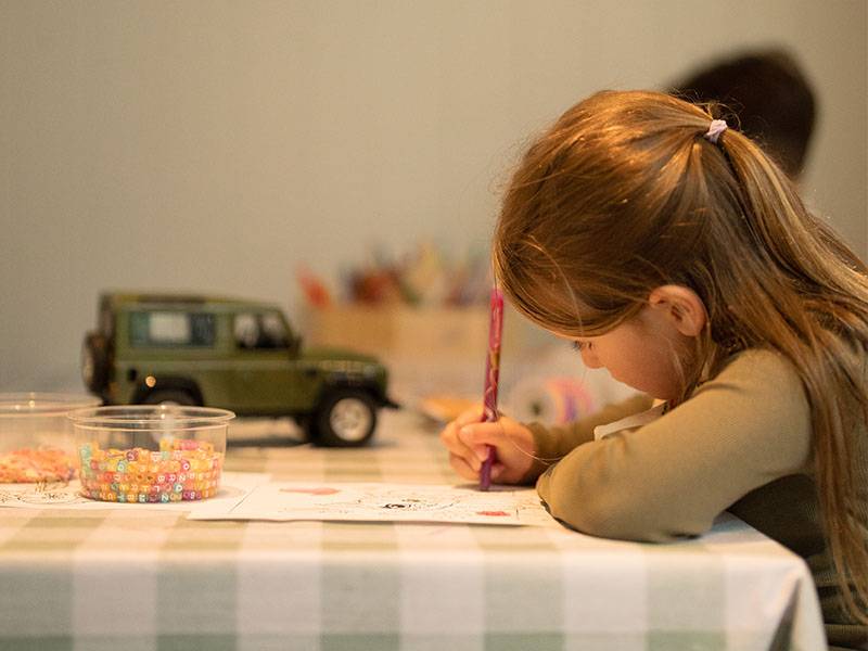Child drawing at table during Gleneagles activities